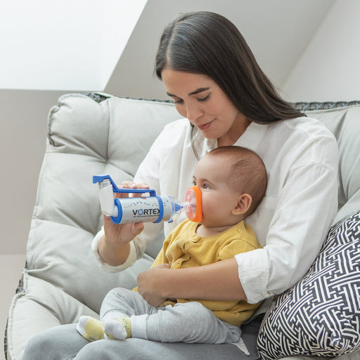 Mother using one handed operation PARI VORTEX Non-Electrostatic Holding Chamber/Spacer on baby