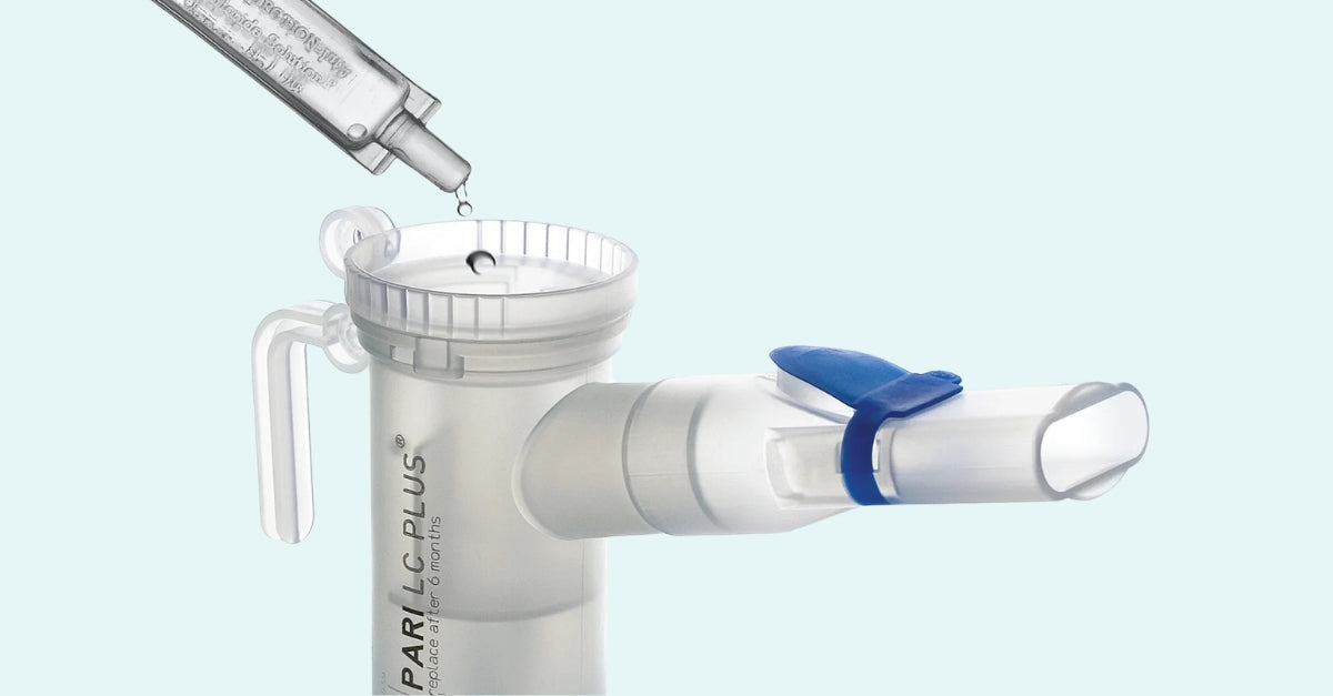 Liquid medication being poured into a Pari LC Plus nebulizer cup.