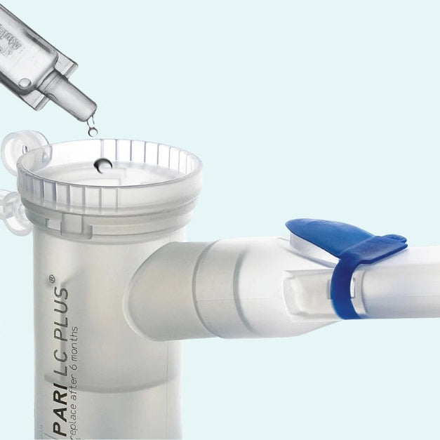 Liquid medication being poured into a Pari LC Plus nebulizer cup.
