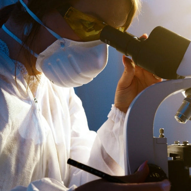Scientist looking under a microscope