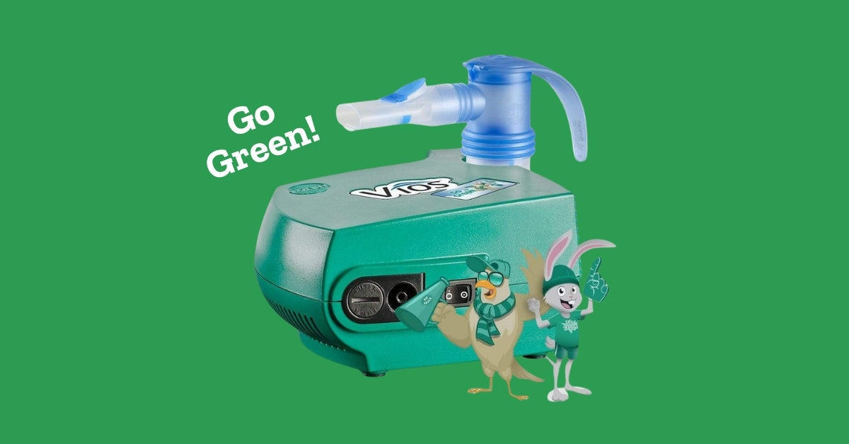 Teal Vios nebulizer machine with attached mouthpiece, accompanied by 'Go Green!' text and two cartoon mascots.