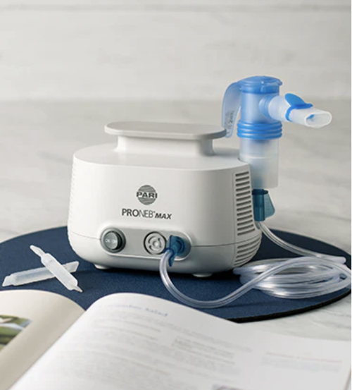 PARI PRONEB Max Nebulizer System with LC Sprint next to book